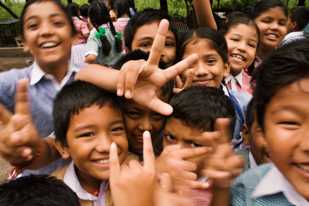 pexels-photo-764681 A joyful group of children smiling and making playful gestures outdoors in Namarjung, Nepal.